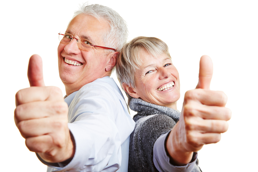 Happy elderly senior couple holding thumbs up